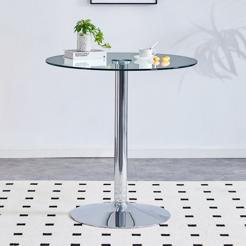 The modern and simple round glass dining table is equipped with silver-plated legs and is suitable for various scenarios