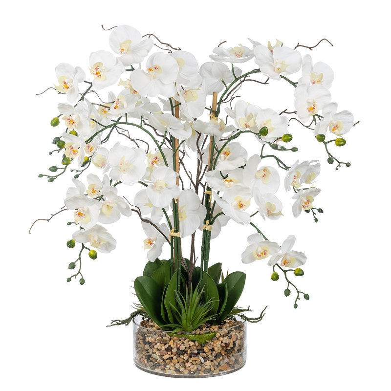 Arrangement floral d'orchidées phalaenopsis artificielles dans un vase en verre