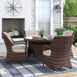 Guyer 4 - Person Wicker Patio Dining Set with Round Table , Cushions Included