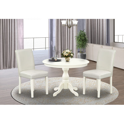 L'ensemble de table de salle à manger 3 pièces comprend une table de cuisine ronde avec piédestal et 2 chaises de salle à manger Parson en similicuir blanc, lin blanc
