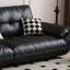 Causeuse-coussin modulable noire en cuir véritable
