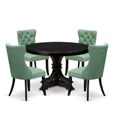 L'ensemble de salle à manger 5 pièces comprend une table ronde de 48 po avec piédestal et 4 chaises rembourrées vert saule, noir sablé