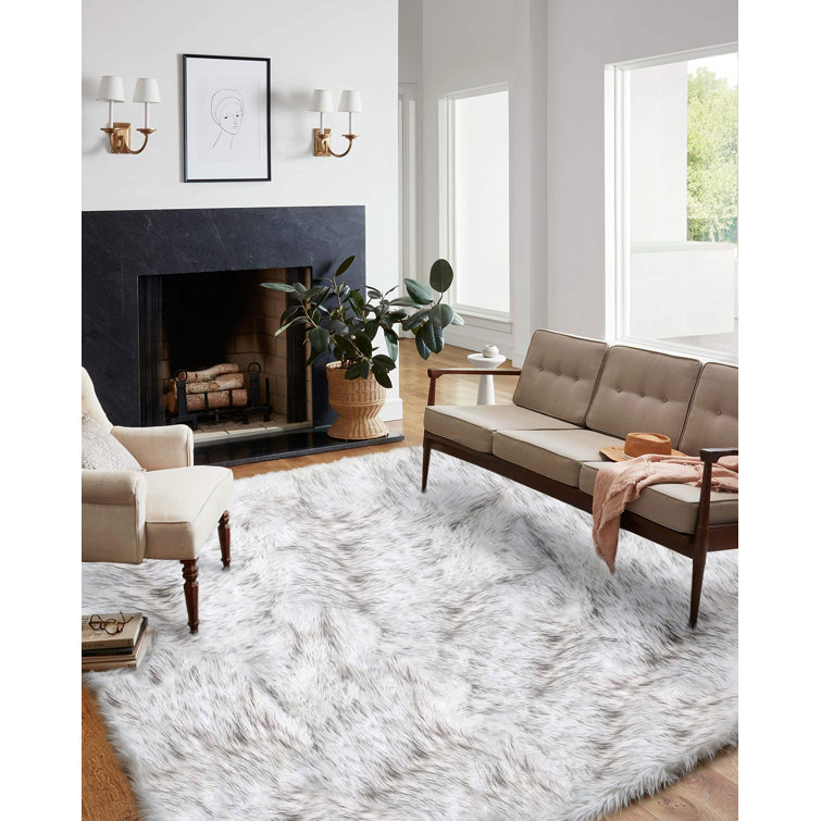 https://assets.wfcdn.com/im/30855216/resize-h755-w755%5Ecompr-r85/2206/220672547/Handmade+Faux+Sheepskin+White%2FGray+Rug.jpg