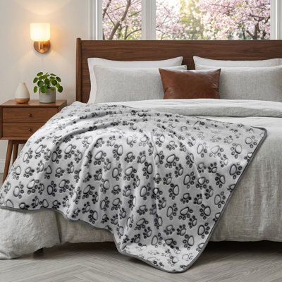 Superior Softness Dog Blanket for Various Dog Sizes (Small, Medium, Large). Machine Washable. Weight: 300GSM. Warm, Plush Fleece Material. Features a Grey Paw Print Pattern. Size: Medium (30"x20"). Suitable for Puppies and Cats.