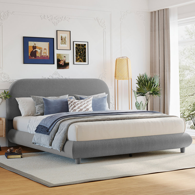 Lit plateforme tapissier avec tissu épais, structure solide et design élégant en forme de courbe