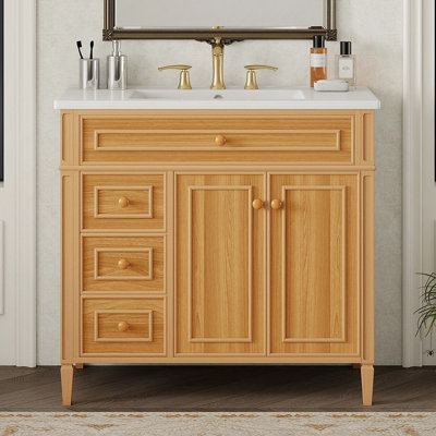 Meuble-lavabo de salle de bain avec lavabo, armoire en bois avec tiroir rabattable, plusieurs options de rangement, portes à fermeture en douceur et poignées élégantes pour les salles de bain modernes