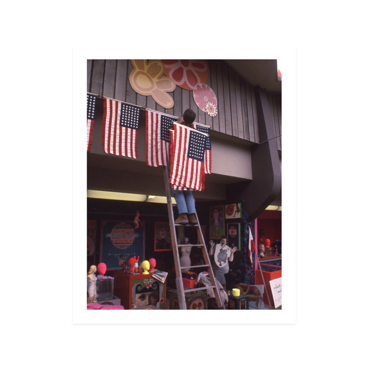 Man Hanging American Flag on Roof - Unframed Photograph