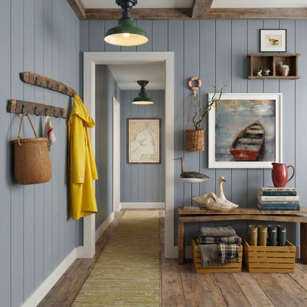 Hallway with blue paneling, wooden accents, and books including Stargater and Aubthor.