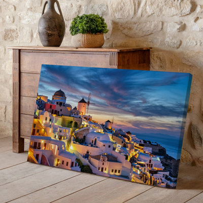 Canvas A Breathtaking Twilight Scene Of Santorini Showcasing A Cluster Of Wall Art Whitewashed Buildings Cascading Down A Hillside Canvas Wall Art