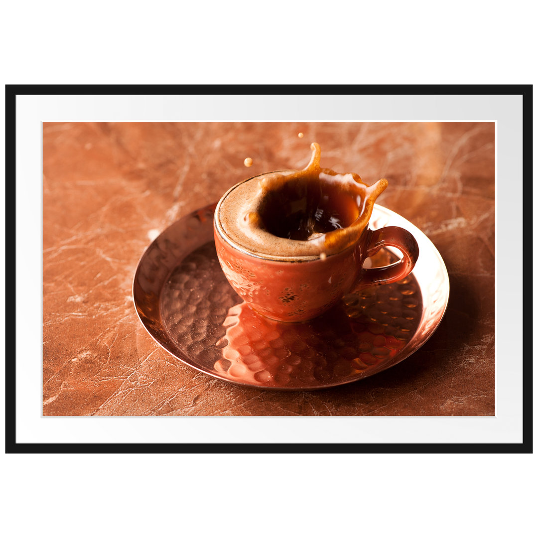 Gerahmtes Poster Kaffee spritzt aus Tasse