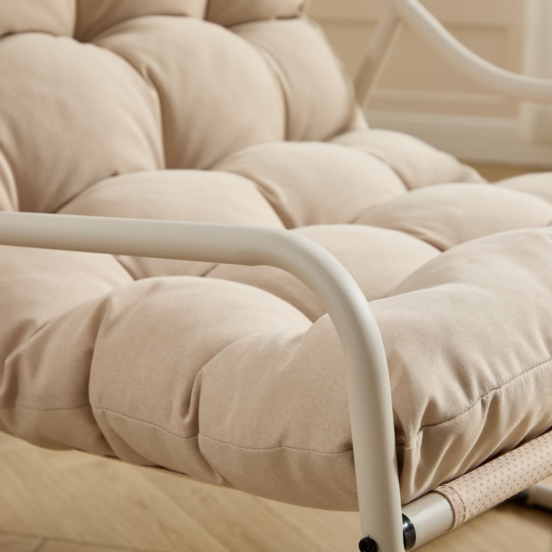 Chaise berçante d'extérieur moderne, structure en acier, coussin beige confortable pour le salon