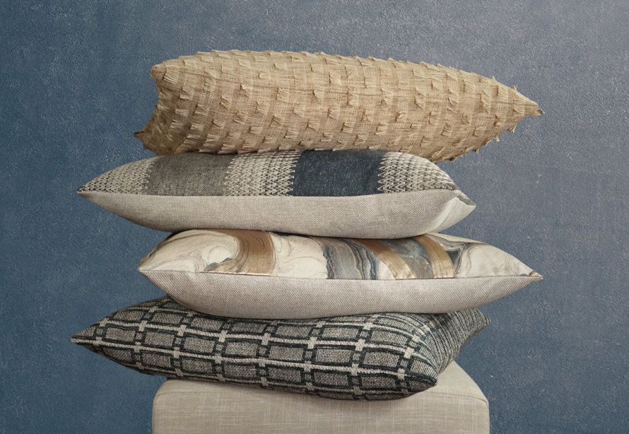 Stacked throw pillows in different patterns.