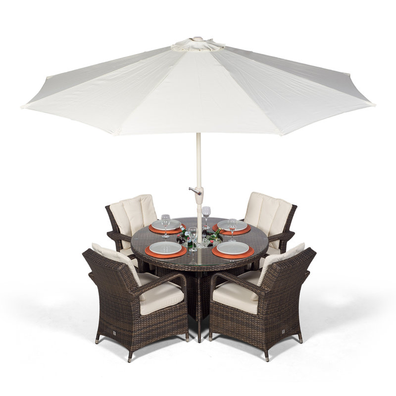Karas 4 - Person Wicker Patio Dining Set with Round Table , Cushions Included, Brown