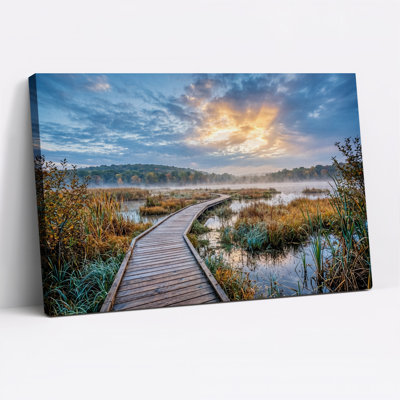 Wooden Boardwalk Through Misty Marsh At Sunrise Canvas Wall Art