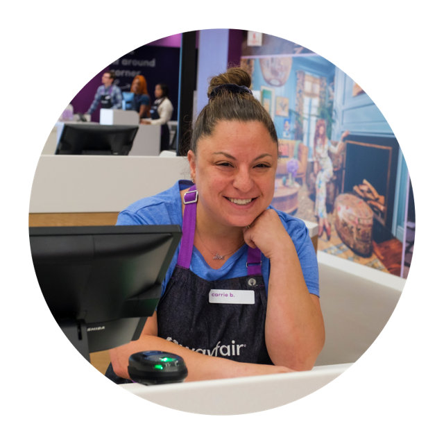 Wayfair employee, Carrie B., smiling at the register.