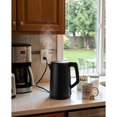 1.7‑liter electric kettle with double‑walled food‑grade stainless‑steel inner tank, multi‑use as coffee or tea maker, features auto shut‑off and boil‑dry protection, 1200‑watt power rating, backed by 2‑year warranty (Black).