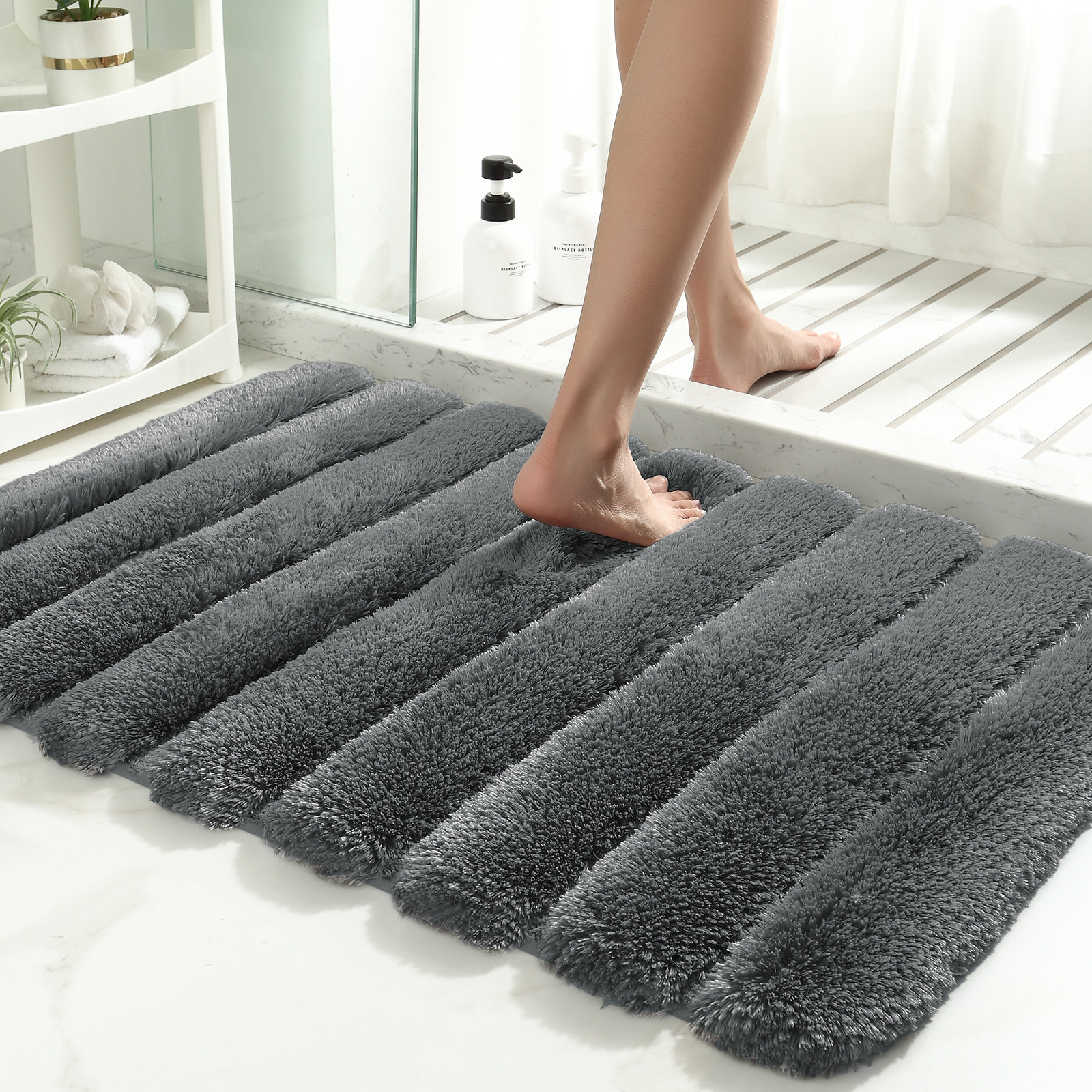 https://assets.wfcdn.com/im/31386787/compr-r85/2498/249899718/decarie-bath-rug-with-non-slip-backing.jpg