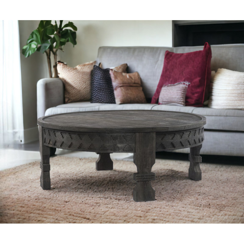 Table basse ronde en bois sculpté noir