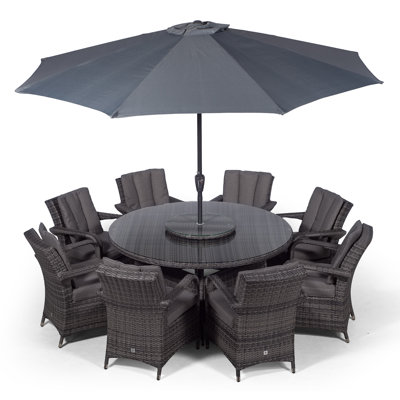 Karas 8 - Person Wicker Patio Dining Set with Round Table , Cushions Included