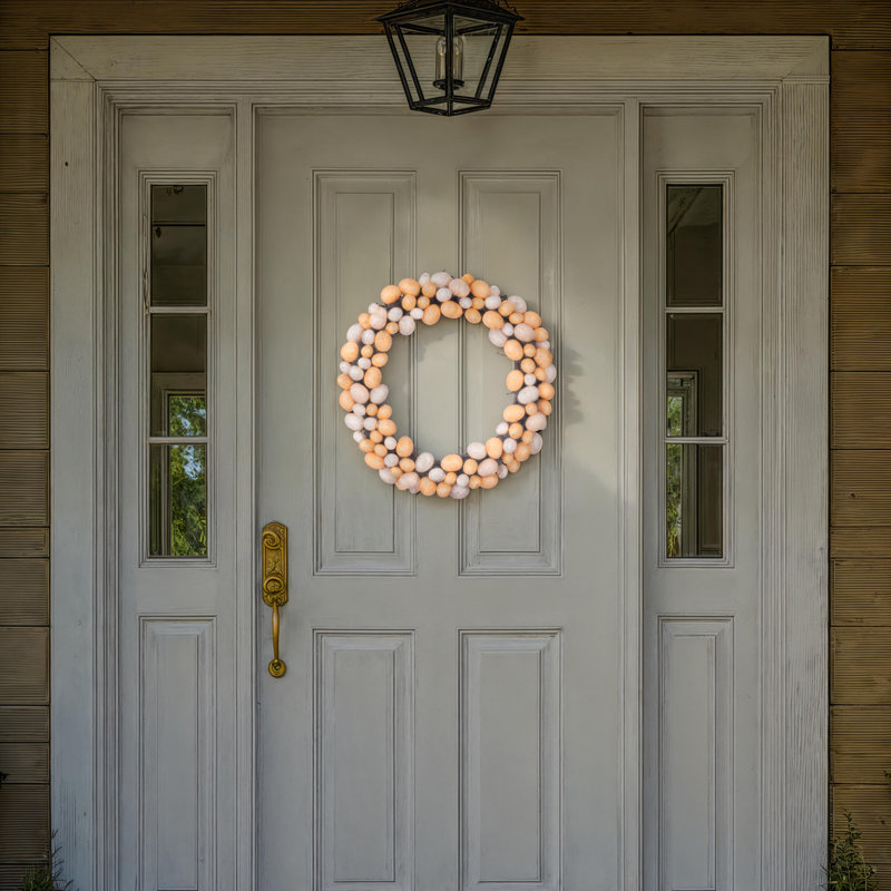 The Holiday Aisle® 18" Artificial Easter Eggs Wreath. Features Easter eggs on a grapevine base., Pastel Orange