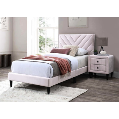 Lit simple avec revêtement en velours et base stable pour une bonne nuit de sommeil