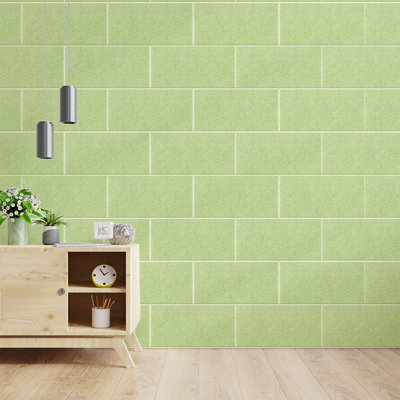 Pale green rectangular soundproof wall panels with beveled edges installed in a living room.