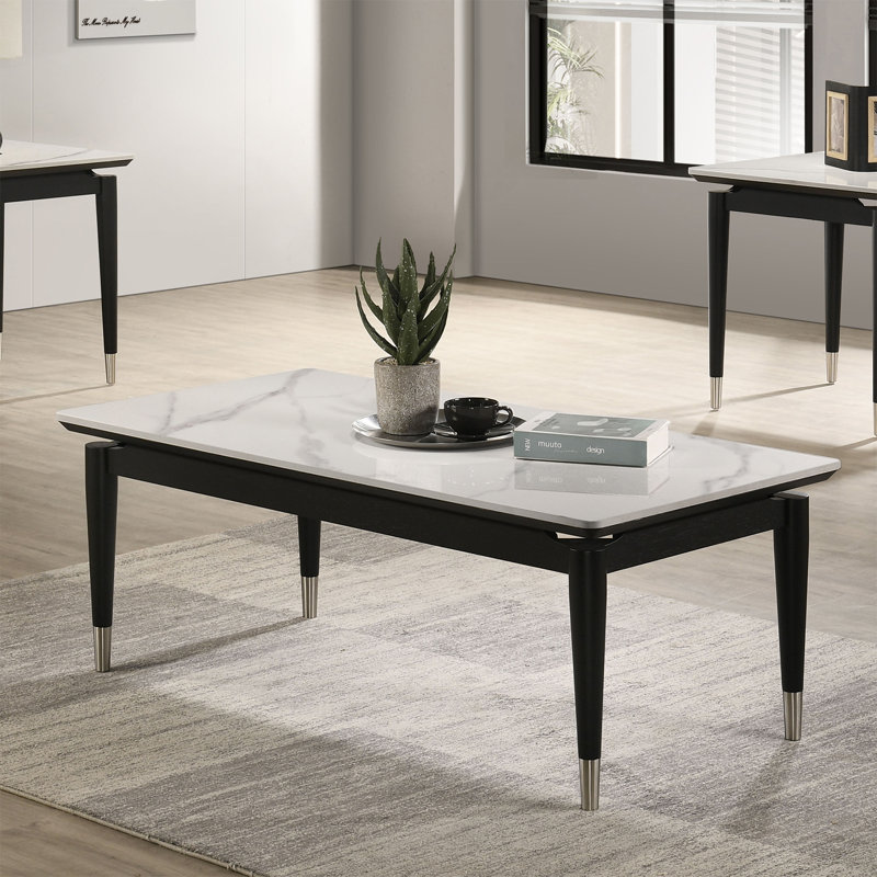 Table basse contemporaine avec plateau en pierre frittée et pieds en flèche argentés, finition noire et blanche | Idée de cadeau