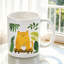 1pc Cute Orange Cat Sitting on Table with Tropical Leaves And Design Ceramic Coffee Mug Coffee Cup Christmas Gift Holiday.