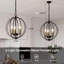 Lustre en forme de chandelier 3 lumières avec globe noir