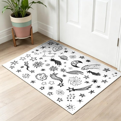 Tapis intérieur noir lavable à la machine, motif étoiles et espace amusants.