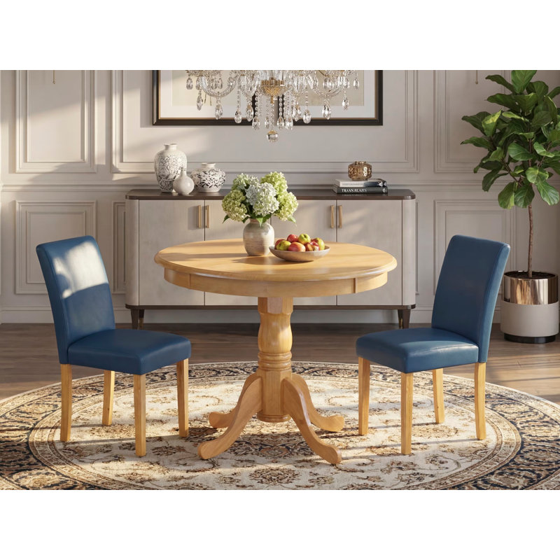 L'ensemble 3 pièces de table et chaises de cuisine comprend une table de salle à manger ronde avec piédestal et 2 chaises Parsons en similicuir bleu Oasis, chêne