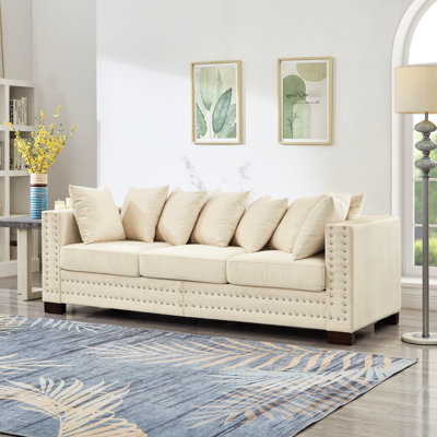 Velours abricot 3 places avec look moderne, accoudoirs carrés, clous argentés, sièges à ressorts ensachés confortables et rangement avec accoudoirs