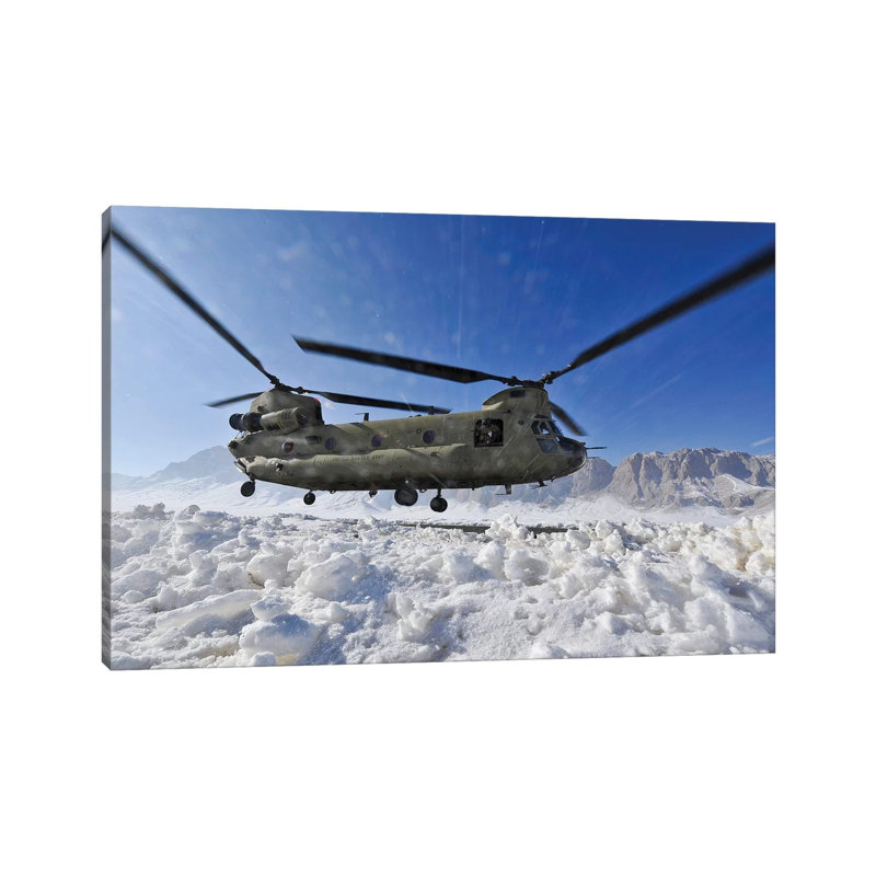 Snow Flies Up As A US Army CH-47 Chinook Helicopter Prepares To Land by Stocktrek Images - Wrapped Canvas Print