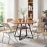Table de cuisine industrielle avec tablette en filet et 4 chaises pliantes rembourrées en métal, petit coin-repas avec coin-repas