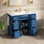 Meuble-lavabo bleu marine 48 po avec lavabo en céramique - 6 tiroirs (3 de chaque côté), tiroir central rabattable, portes doubles à fermeture en douceur, porte-serviettes latéral réversible, poignées argentées, panneau de fibres à densité moyenne