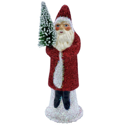 Père Noël en manteau scintillant avec arbre