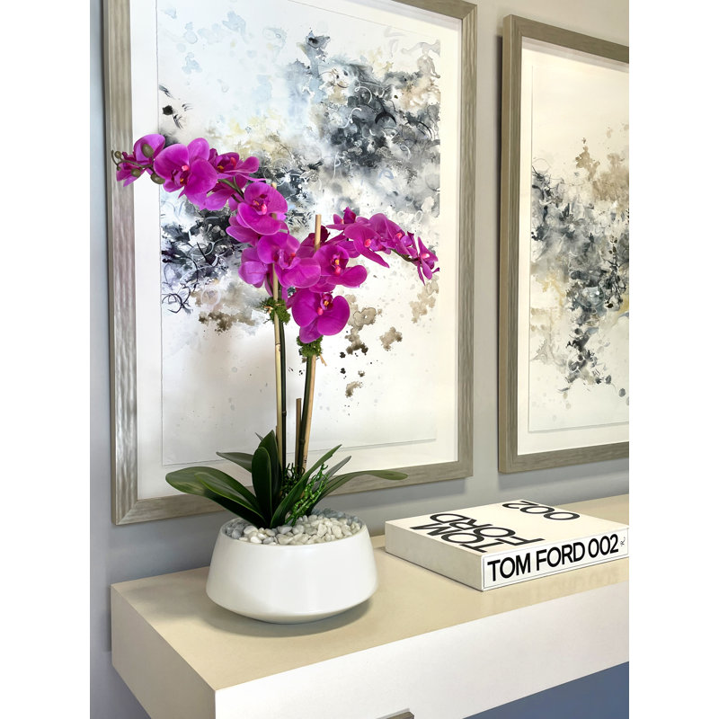 Orchids In A White Container With Rocks