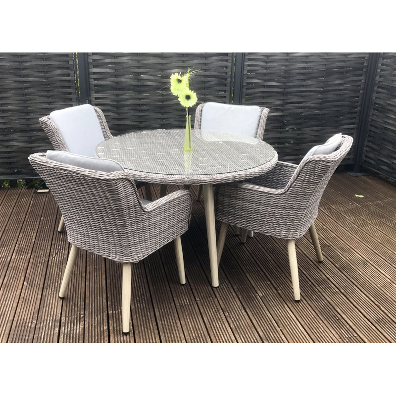 Deanna 4 - Person Wicker Patio Dining Set with Round Table , Cushions Included