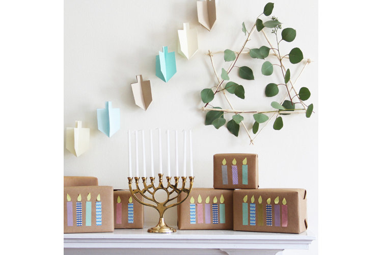 Mantel with menorah, wrapped presents, and dreidel garland.