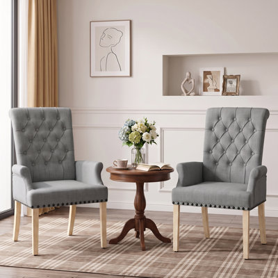 Chaise de salle à manger Amdad capitonnée en tissu avec pieds massifs