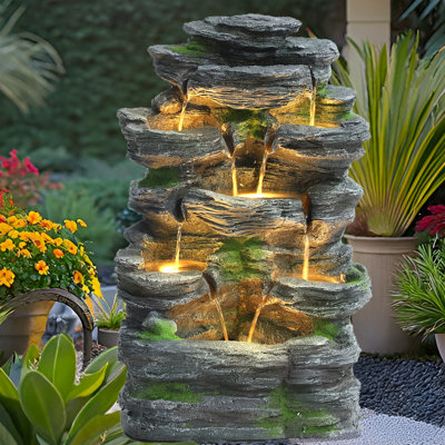 Fontaine d'eau de roche extérieure, fontaines à 7 niveaux avec lumières DEL, chutes d'eau au sol à l'extérieur, fontaine de roche en cascade moderne pour jardin, cour, patio, décoration intérieure