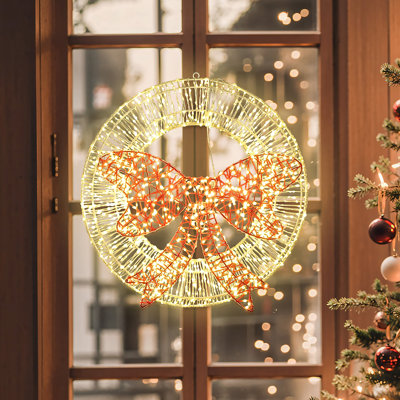 Décoration de Noël avec couronne lumineuse et nœud rouge avec minuterie