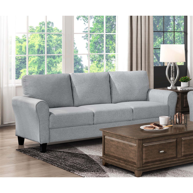Canapé moderne une pièce avec un design arrondi et un revêtement en tissu texturé, adapté à divers styles de décoration intérieure