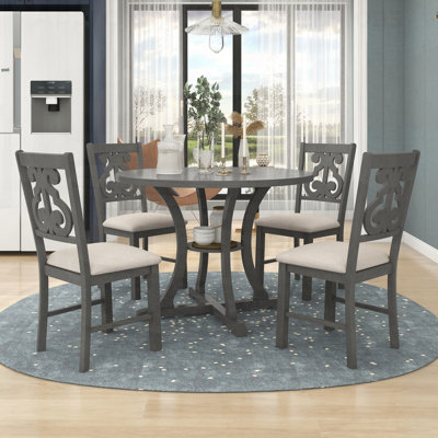 Ensemble 5 pièces de table de salle à manger et de chaises rondes avec des pieds de forme spéciale et un dossier creux de conception exquise pour une salle à manger élégante