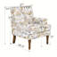 Chic fauteuil floral avec garniture cloutée, imprimé doré et gris, pieds en bois massif, idéal pour les décors campagnards et transitionnels