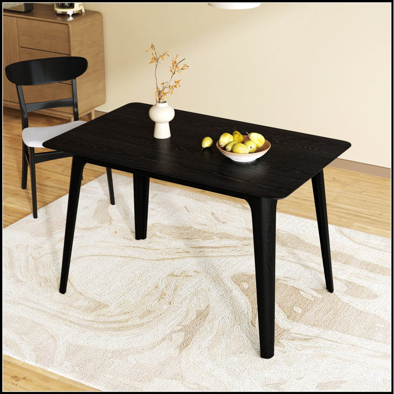 Table de salle à manger de style Mid-Century moderne avec pieds en bois massif et finition noire élégante pour les espaces compacts