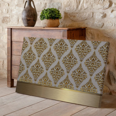 La toile crée un design de papier peint élégant avec un motif damassé complexe en or chatoyant contre un taupe doux
