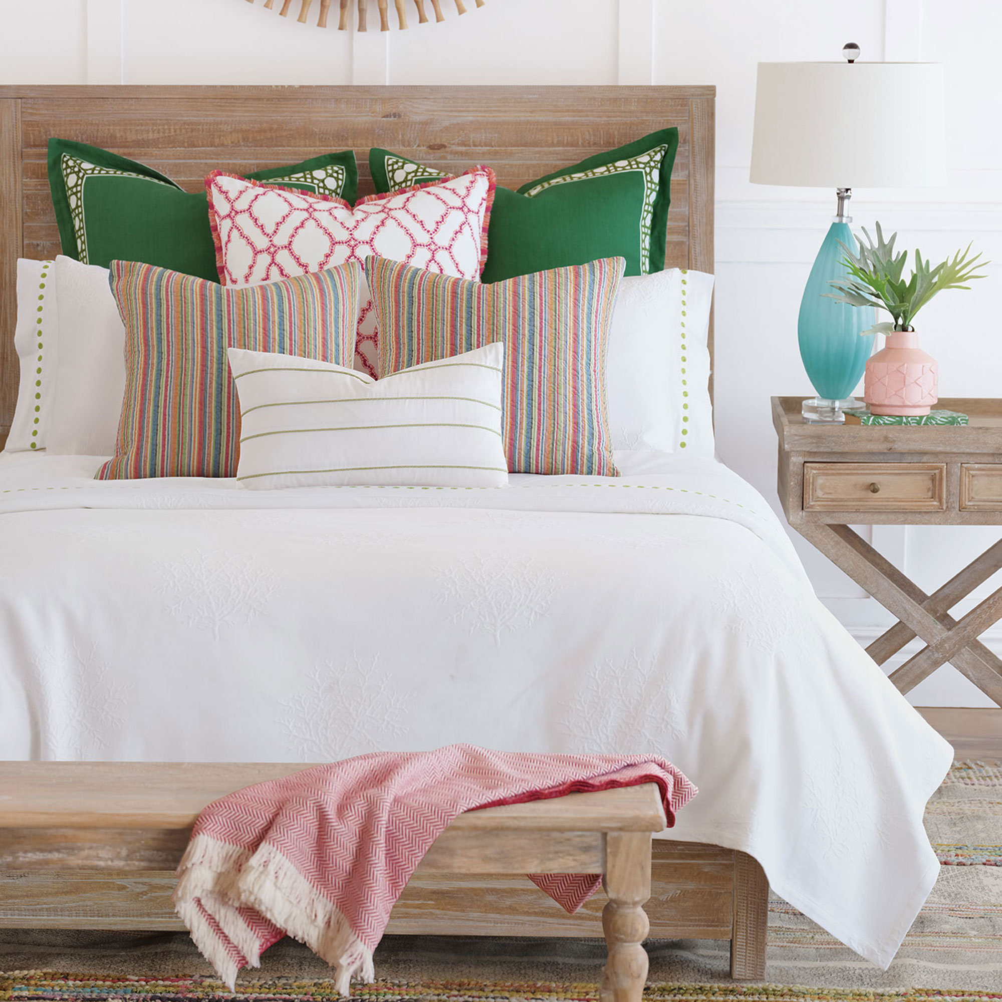 white bedding with accent pillows