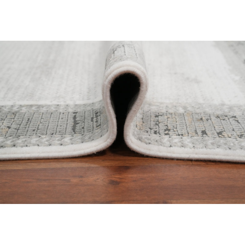 Tapis minimaliste 5 x 7 pour espaces modernes dans des tons ivoire et gris doux