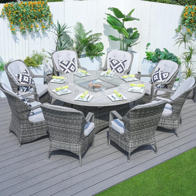 Natascha 8 - Person Wicker Patio Dining Set with Round Table , Cushions Included